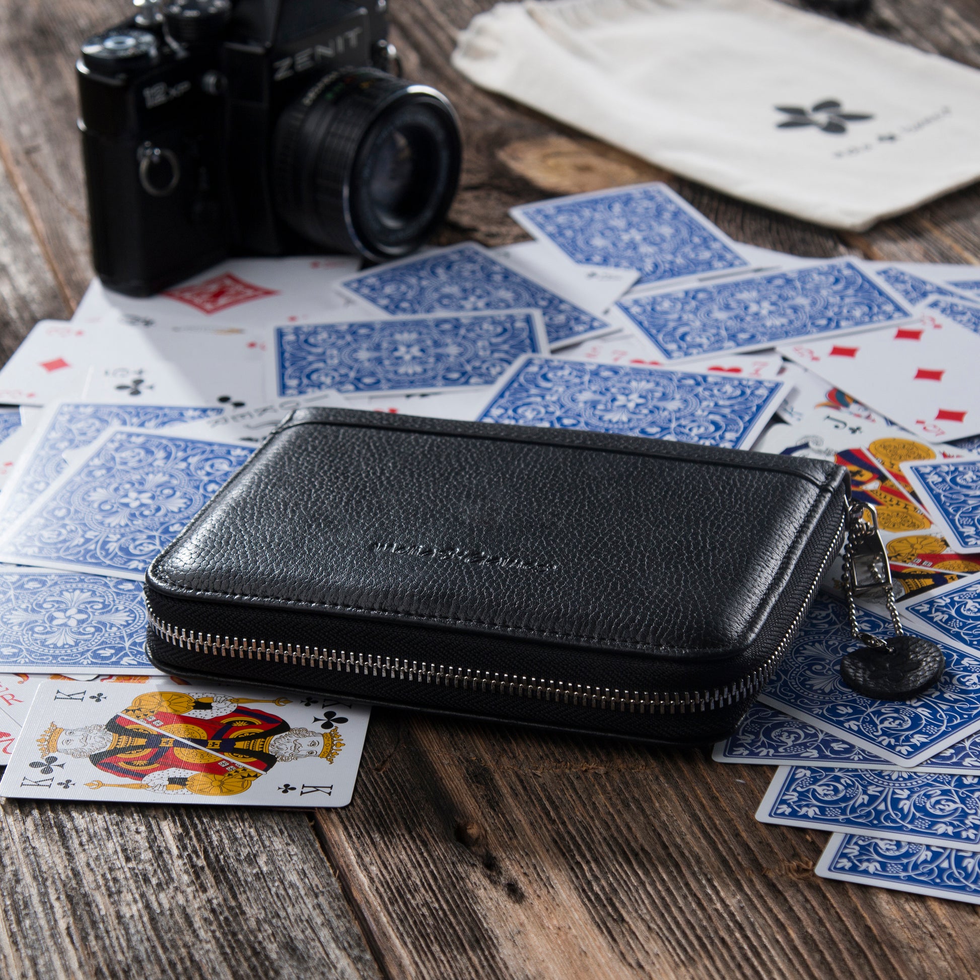 Black MELIA leather playing card case with playing cards for travel and game nights
