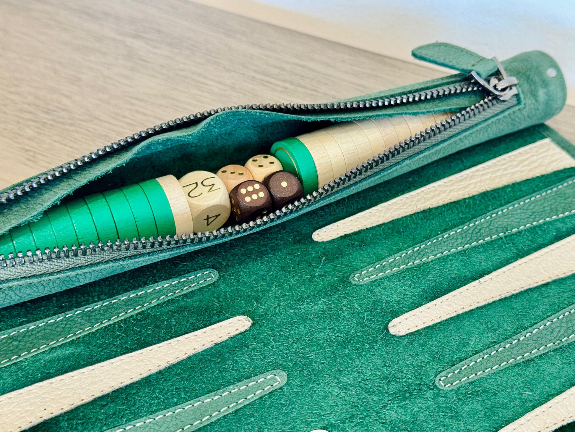 Integrated leather storage with green and cream checkers in MELIA Celtics backgammon set