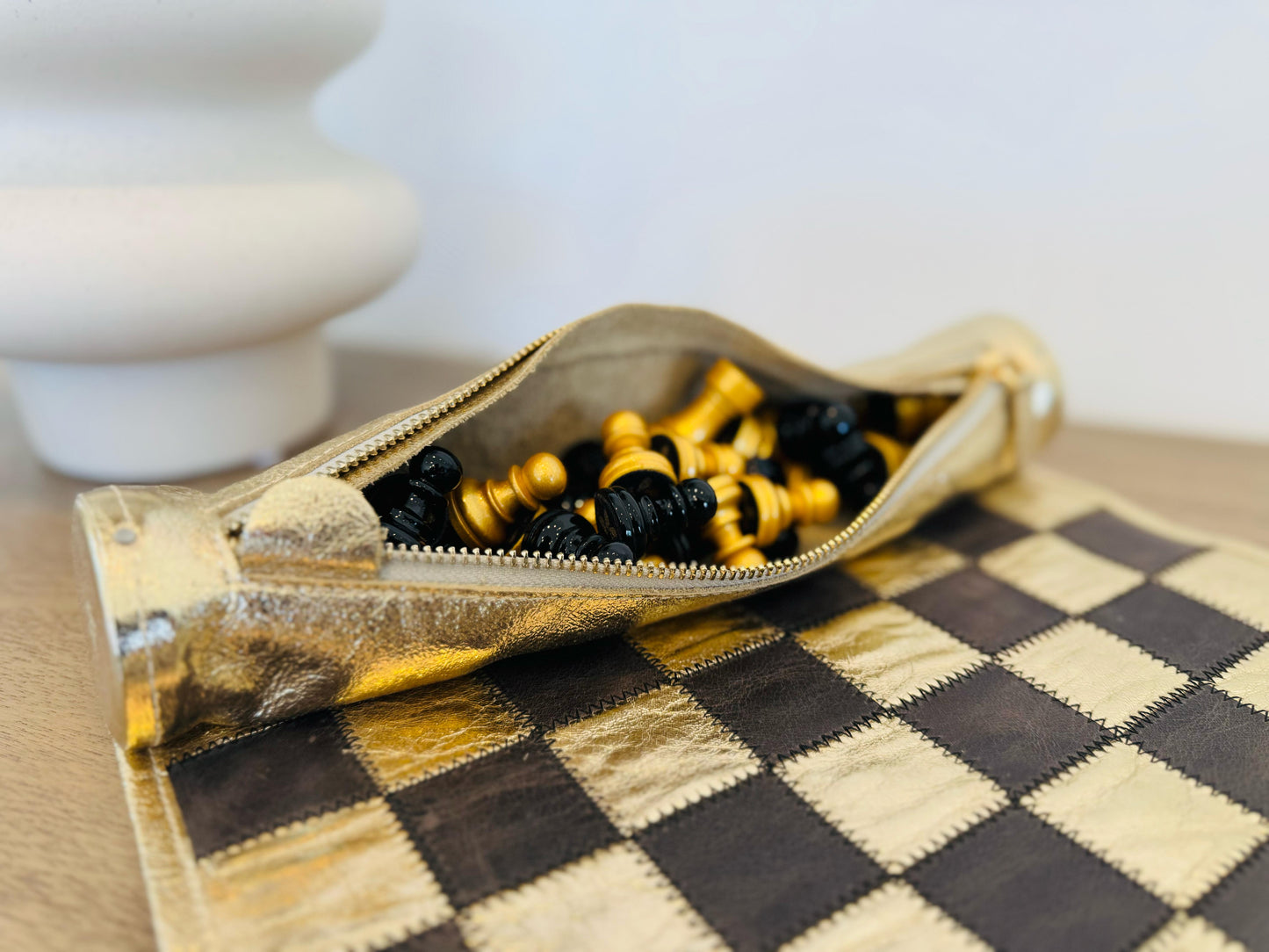Close-up of black and gold magnetic chess pieces