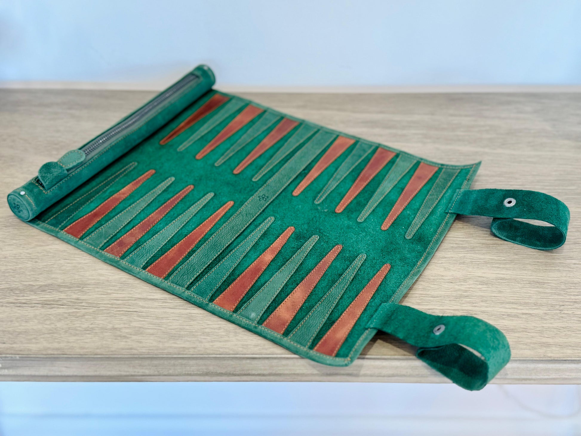 Hunter green nubuck backgammon board showing individually stitched leather points