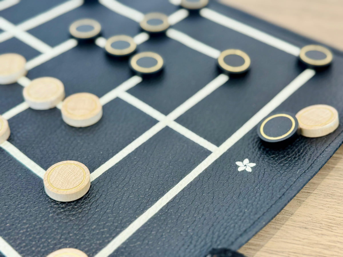 Wooden playing pieces on MELIA leather Nine Men's Morris board