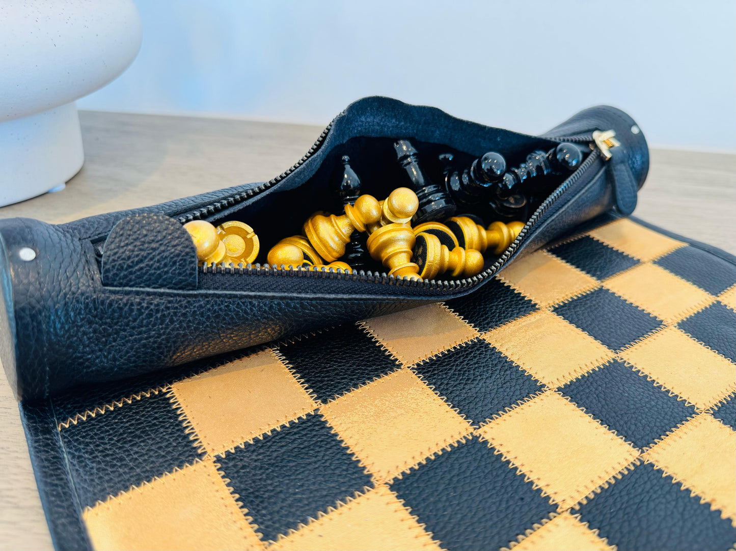Leather storage compartment with gold and black chess pieces