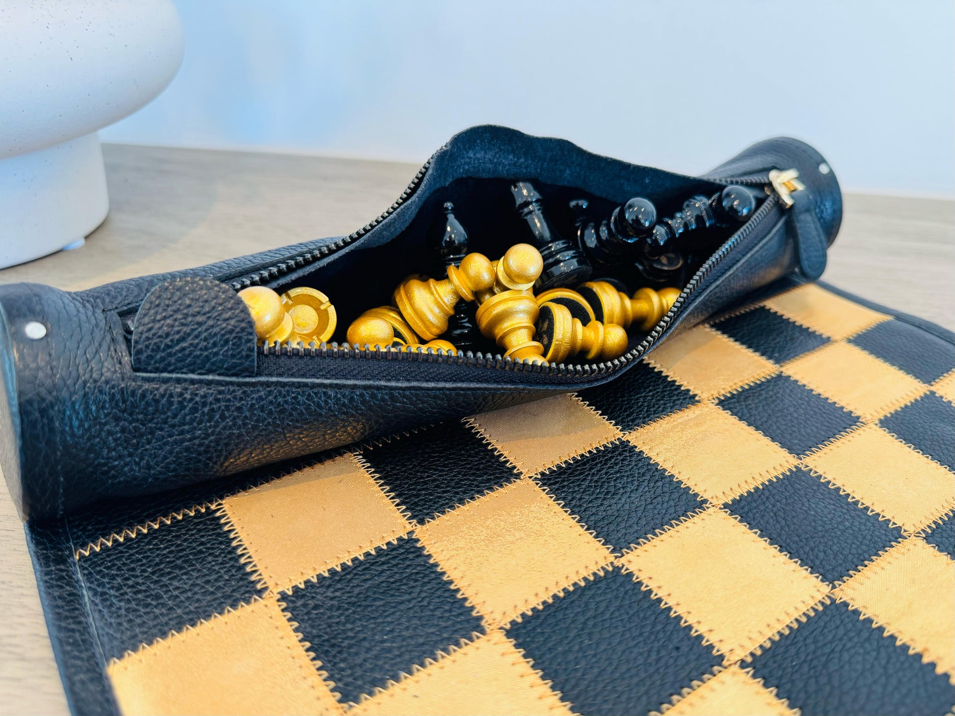 Leather storage compartment with gold and black chess pieces