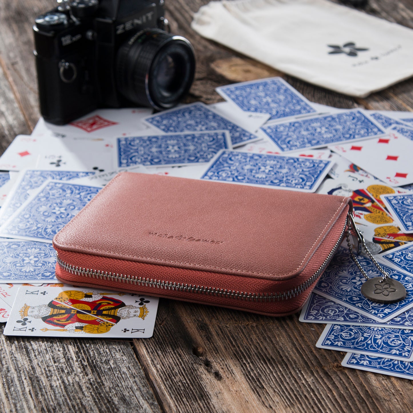 MELIA Coral Red leather playing card case with playing cards during travel