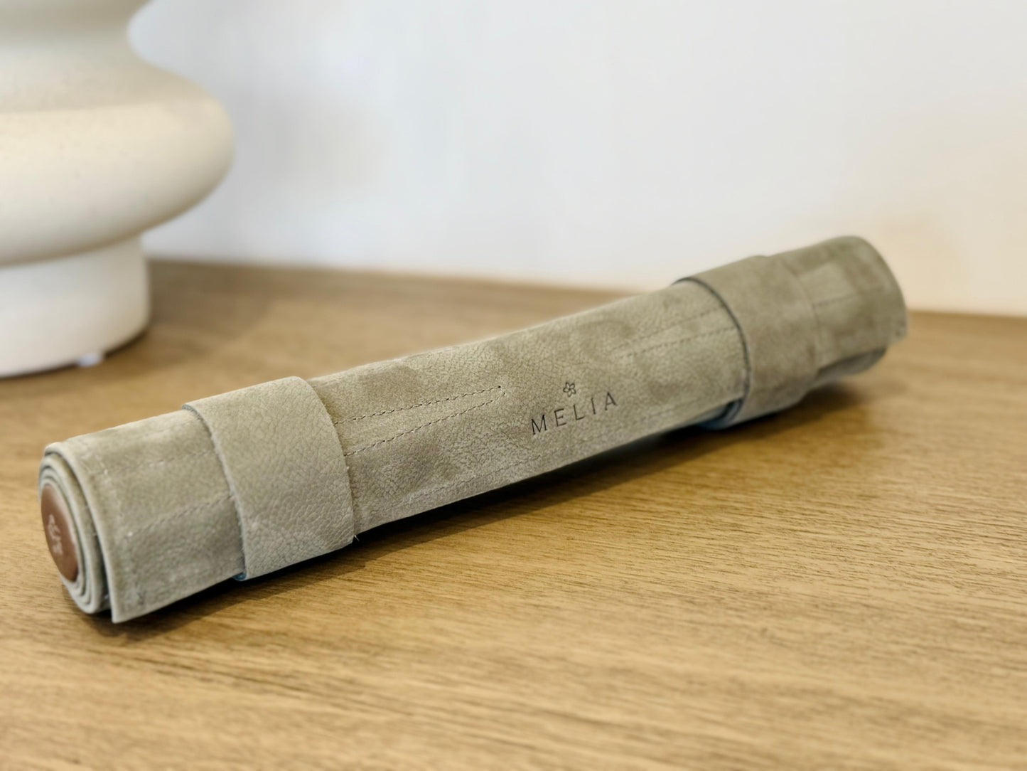 Rolled MELIA Champagne leather backgammon set ready for travel