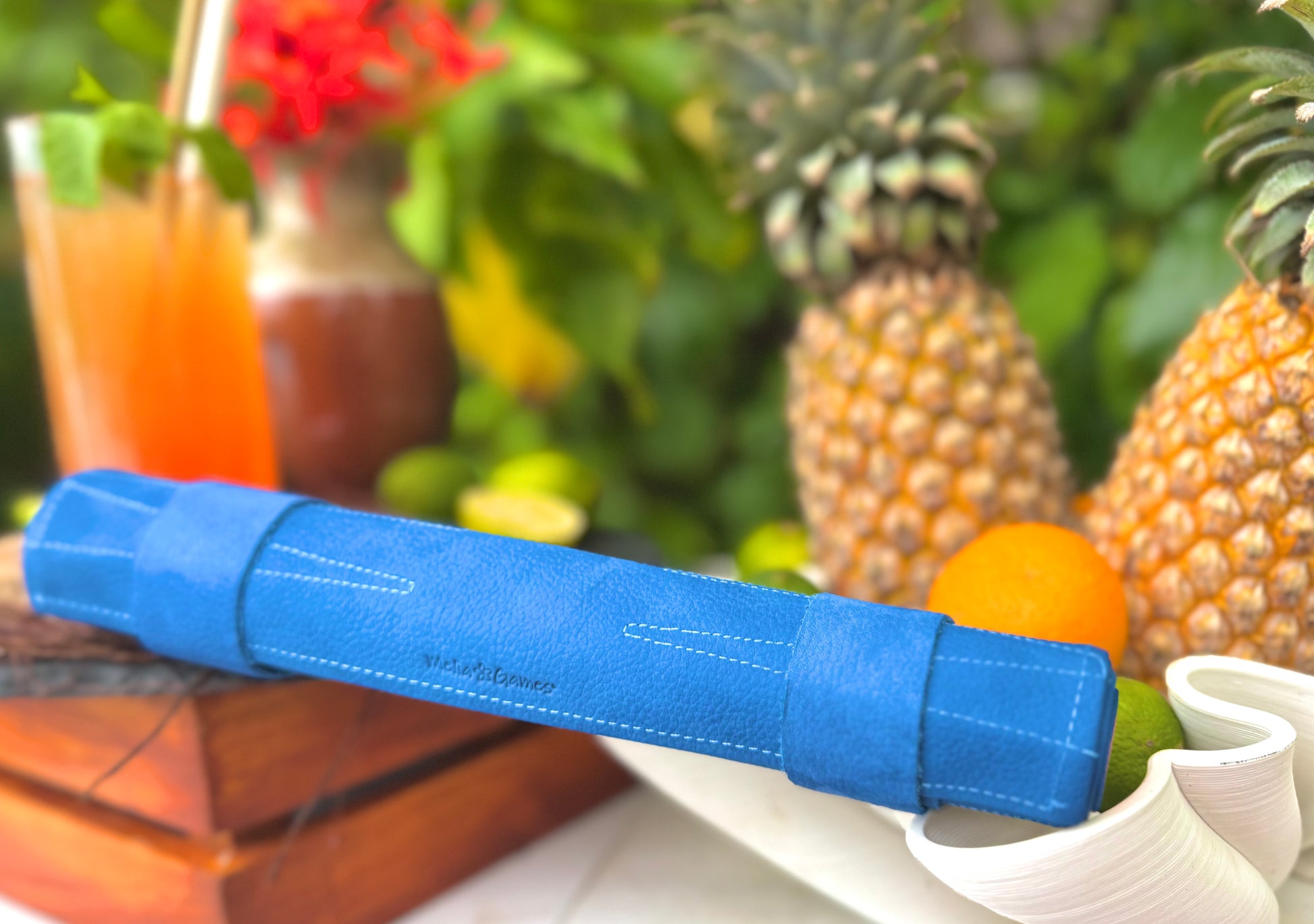 Rolled MELIA Tropicana blue leather backgammon set with tropical travel accessories