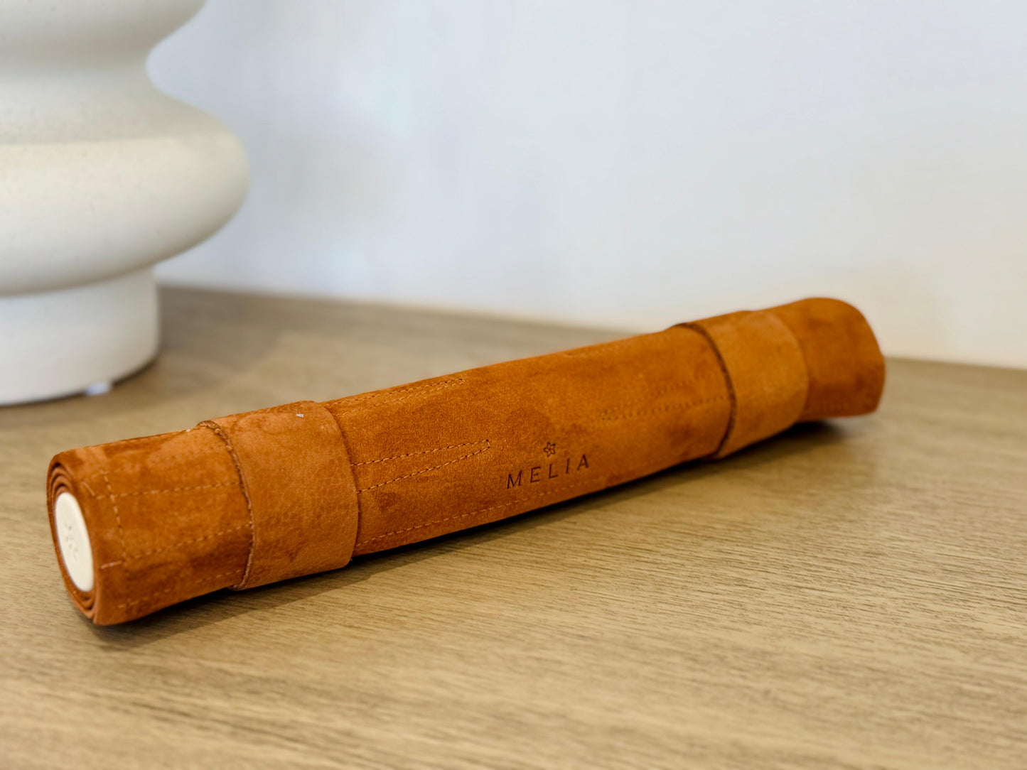 Rolled MELIA Whiskey leather backgammon set showing its compact travel design