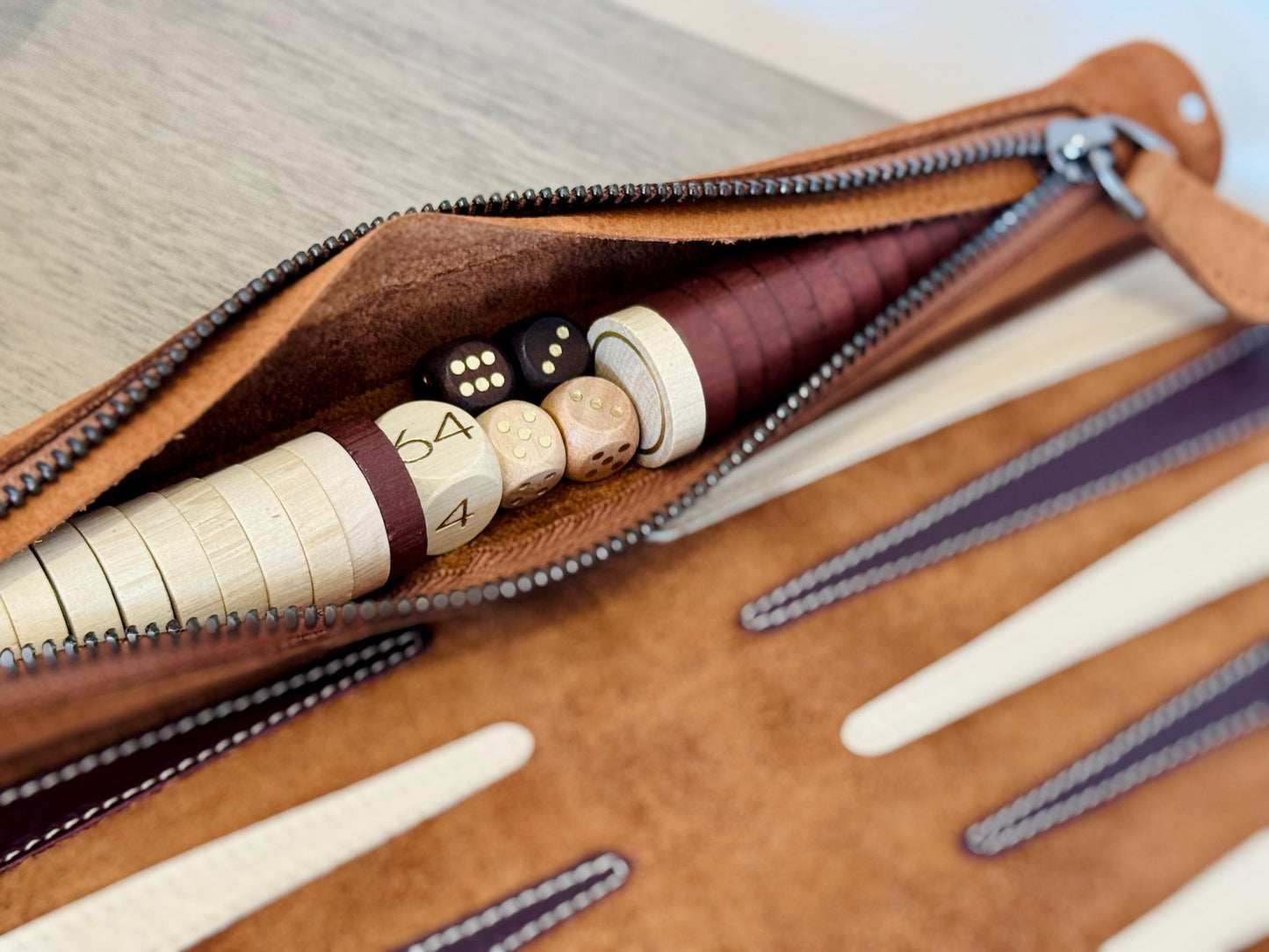 Wooden backgammon checkers and stitched leather points on the MELIA Whiskey set