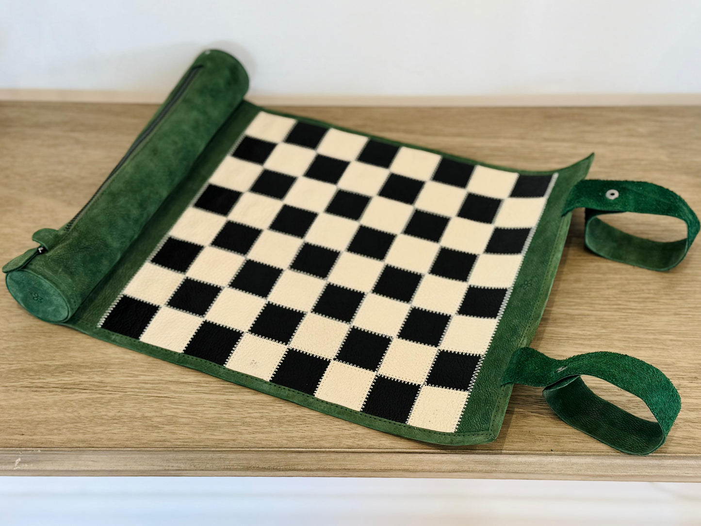 Folded Genève magnetic leather chess set with leather carrying strap